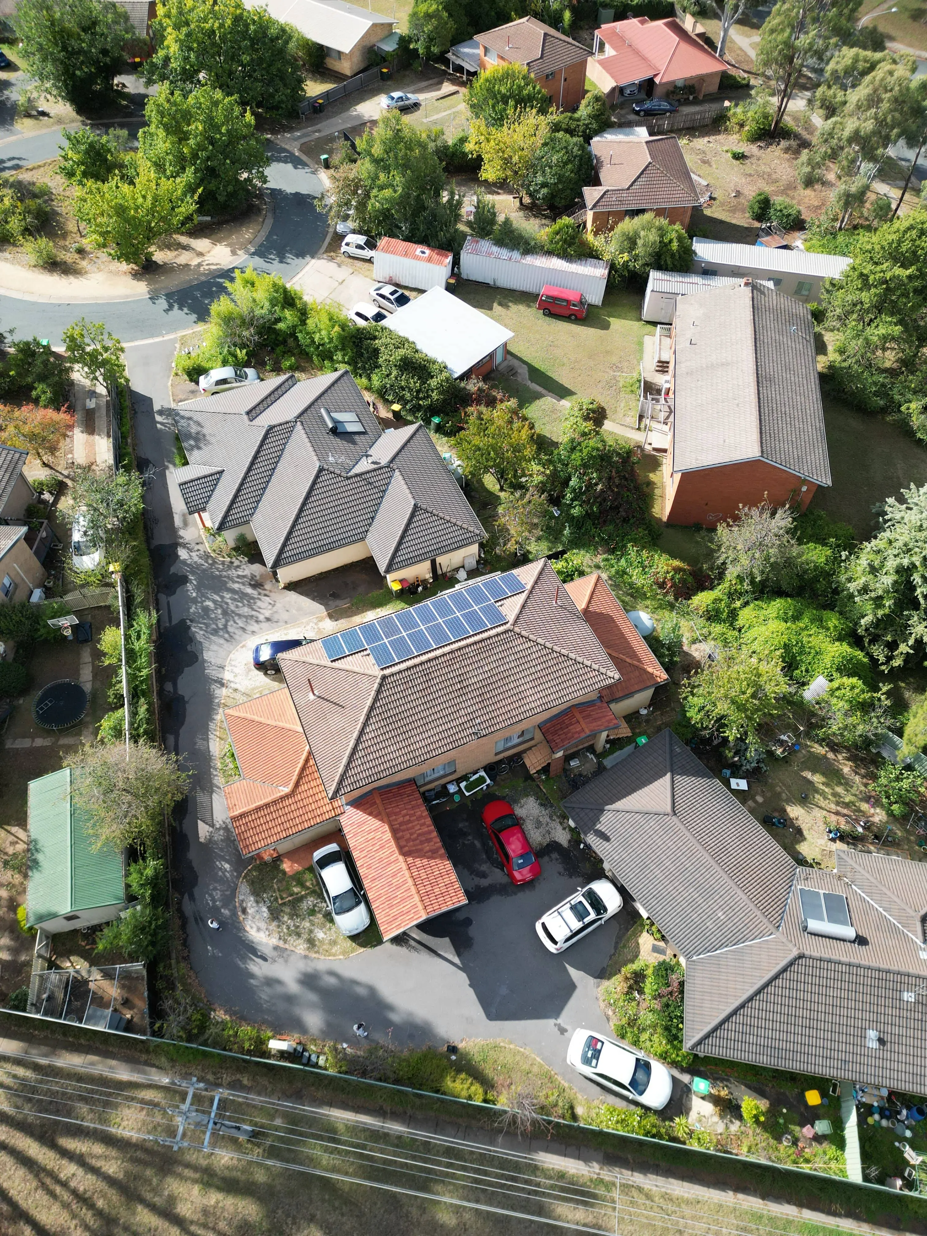 Aerial view of house with solar panels and multiple rooflines