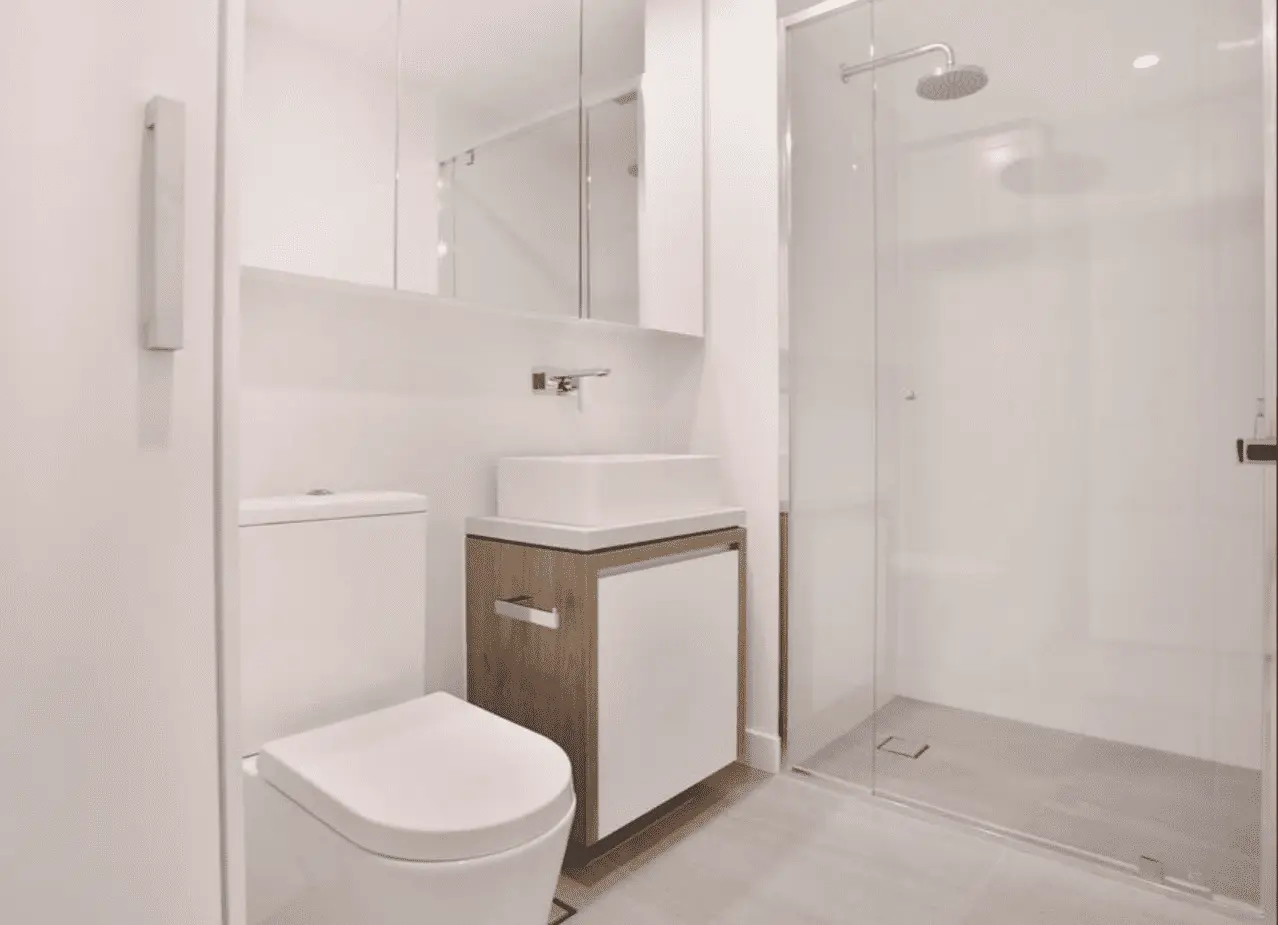 Modern white bathroom with timber vanity and glass shower