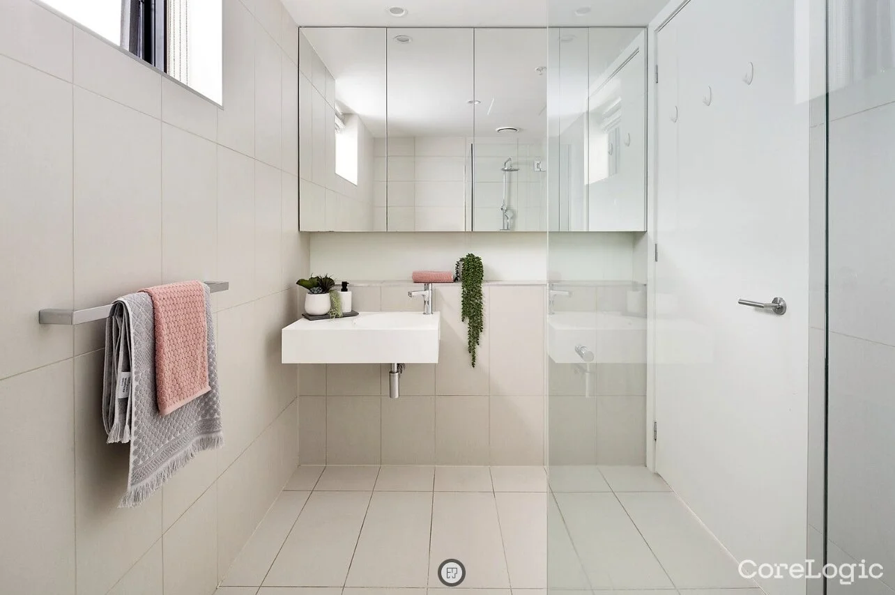 Modern white bathroom with floating vanity and glass shower