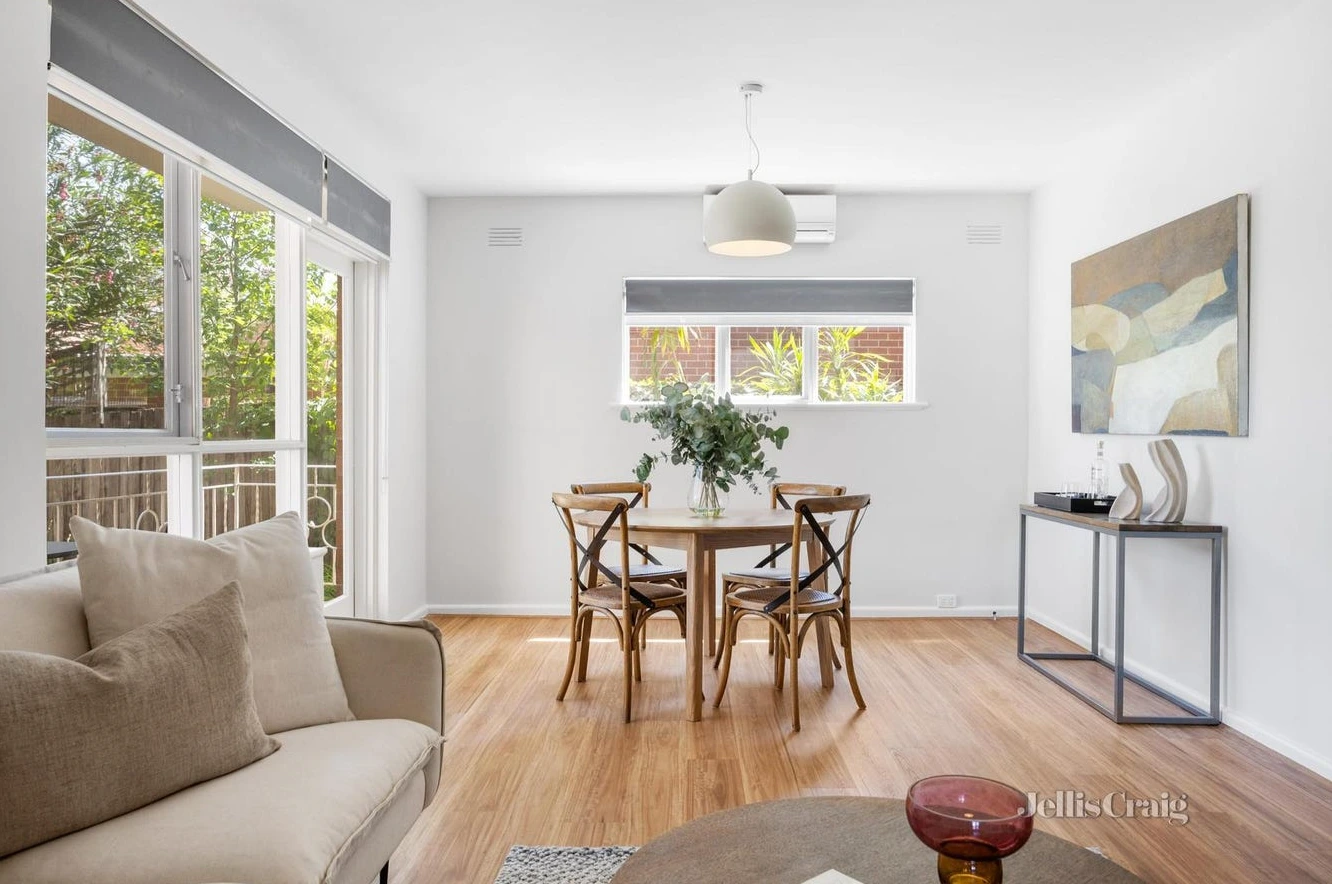 Elegant dining area with wooden table and abundant natural light in Camberwell home purchased below market value by d36 property buyers agent