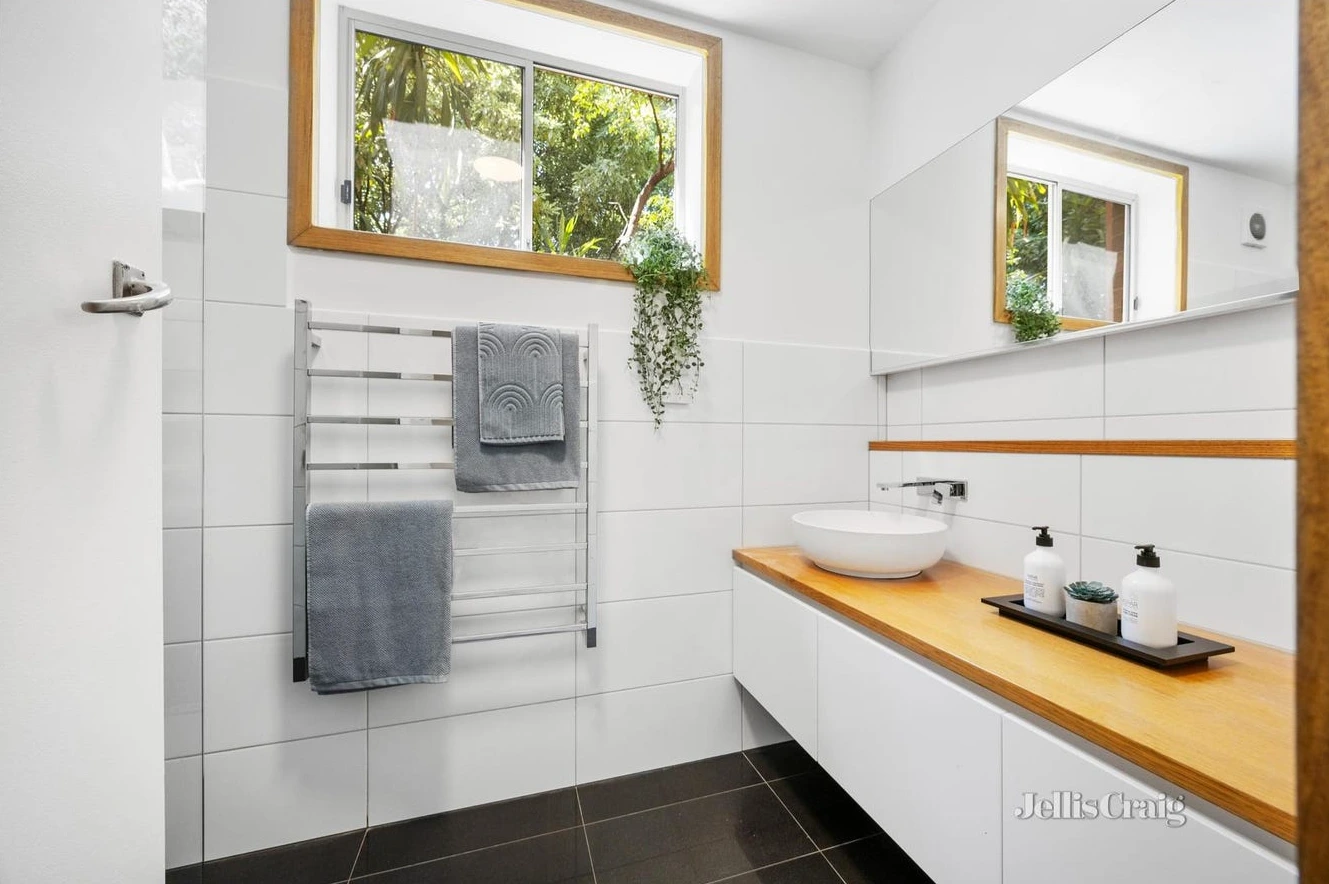 Modern bathroom with timber vanity and garden views in Camberwell home negotiated below market value by d36 property buyers agent