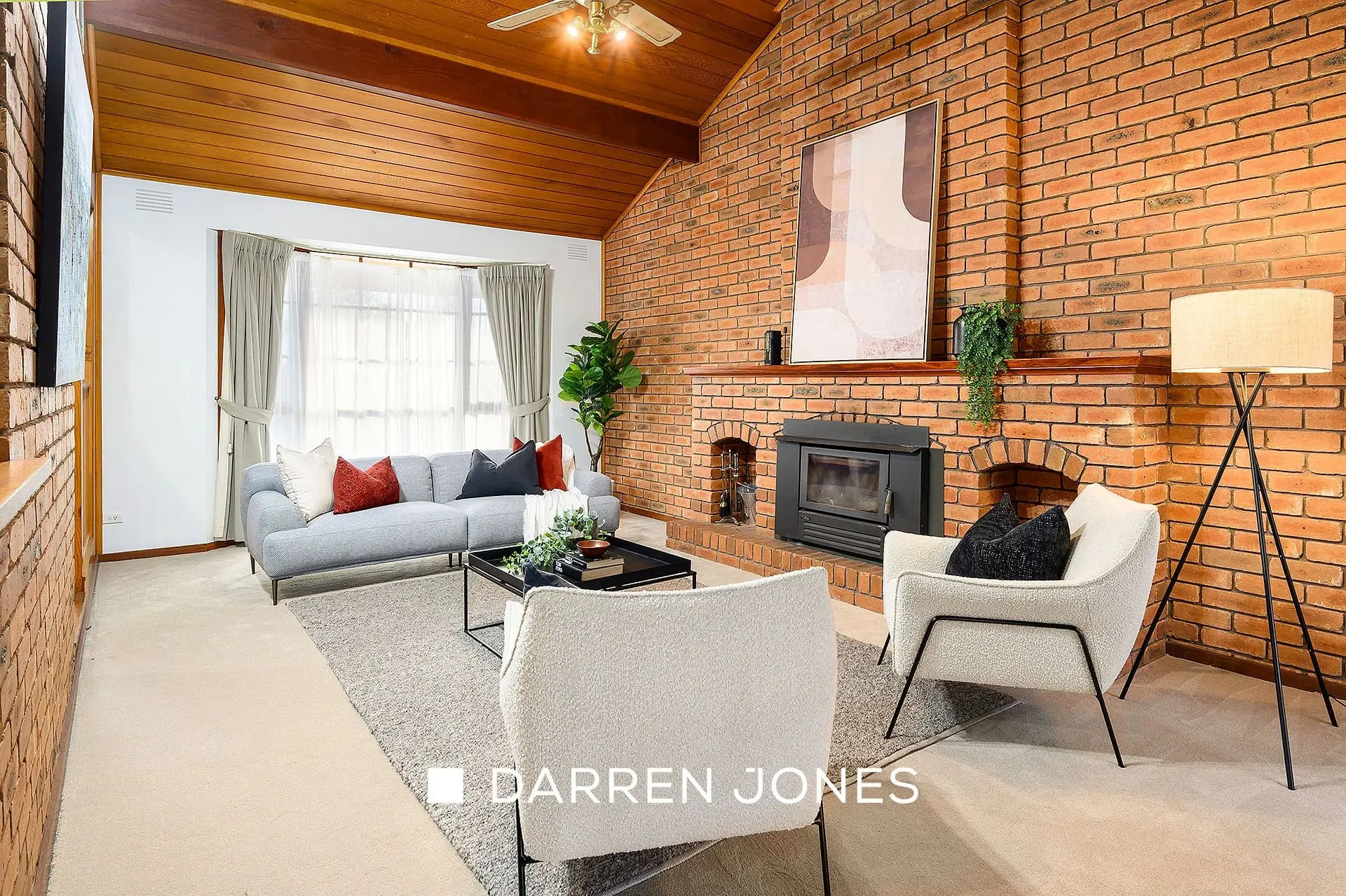 Living room with exposed brick walls, modern furniture, and fireplace