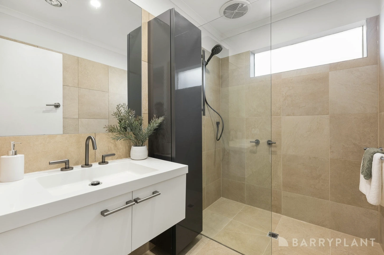A bright and modern renovated bathroom in a Kilsyth home with new white vanity, a large mirror, and updated fixtures.