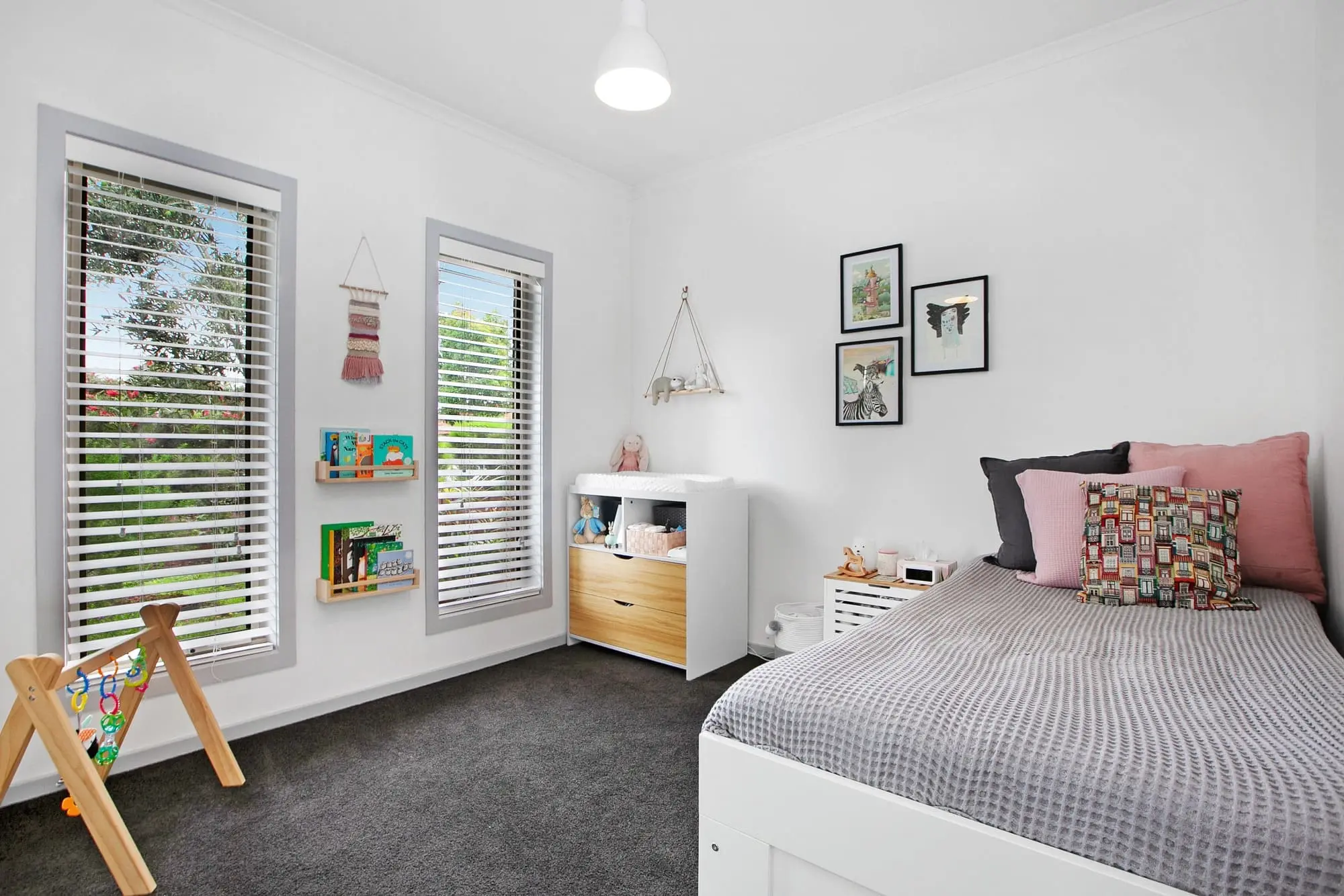 Modern bedroom with book shelves and butterfly artwork