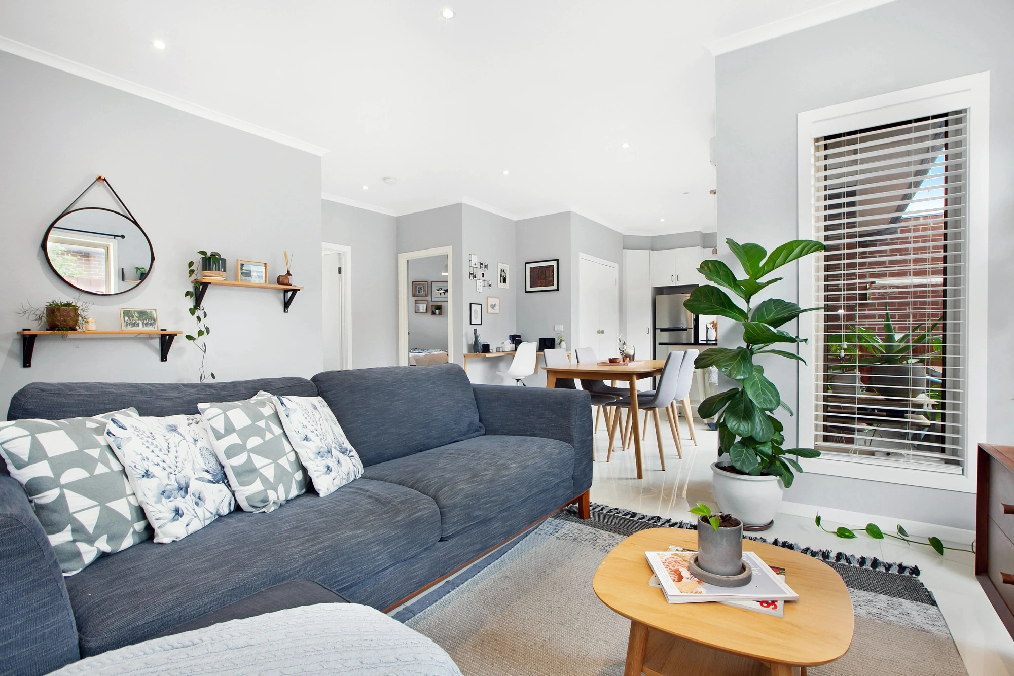 Modern living room with grey walls and blue sofa