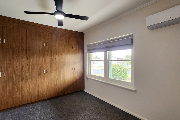 Renovated master bedroom in Mt. Gambier with built-in wardrobe, new air conditioning and modern window treatments