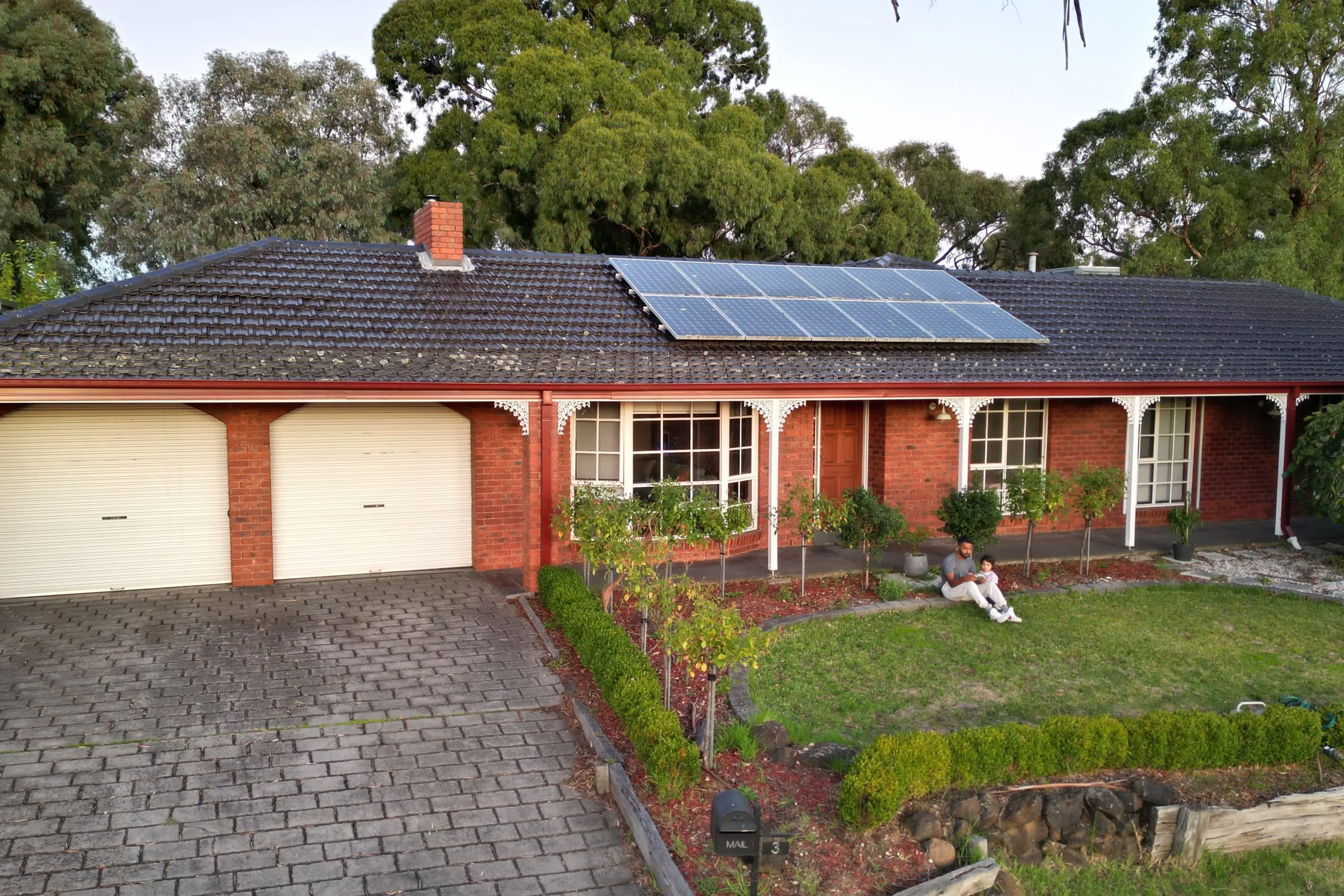 Plenty River brick home renovation with solar panels and landscaping