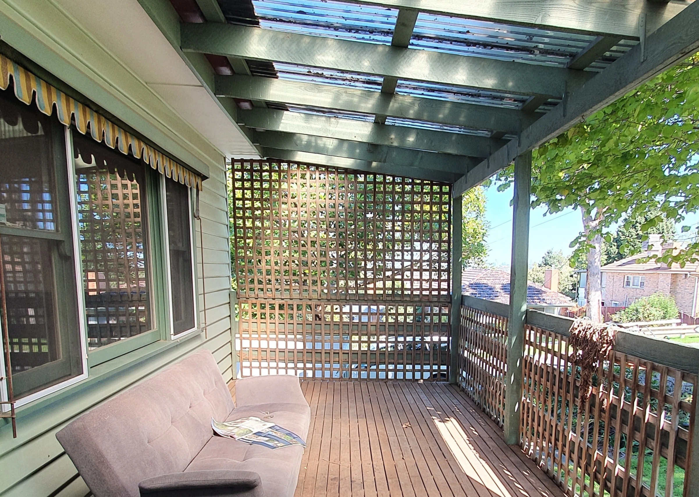 Vintage veranda with wooden lattice screens before renovation
