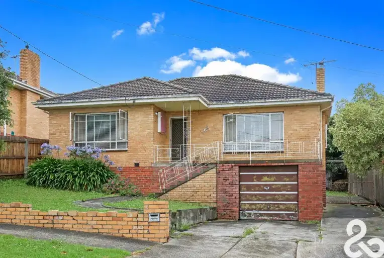 Cream brick house with red brick base and front garden