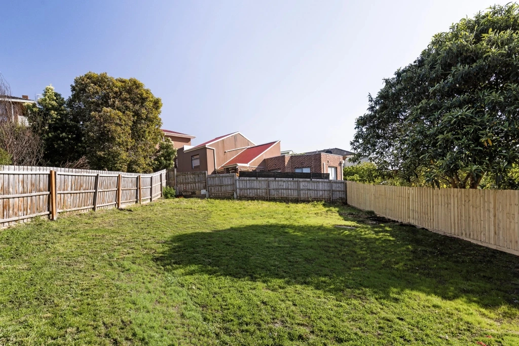 Leveled backyard with new fencing and fresh lawn