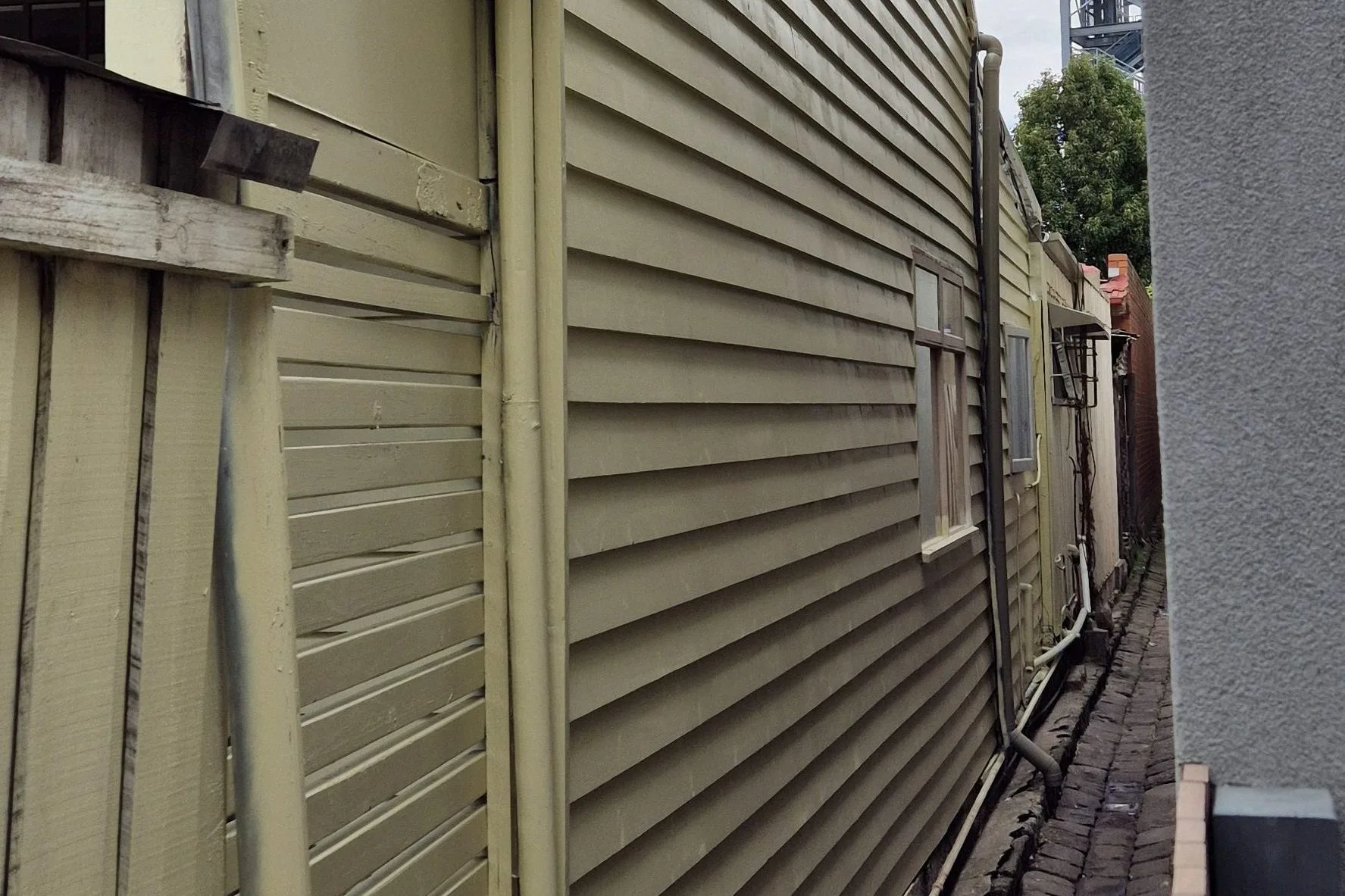 Restored weatherboard exterior with fresh paint in heritage cream