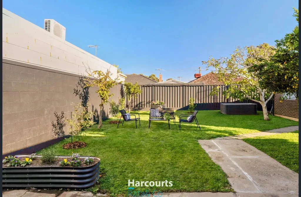 Modern backyard with raised beds and outdoor seating area