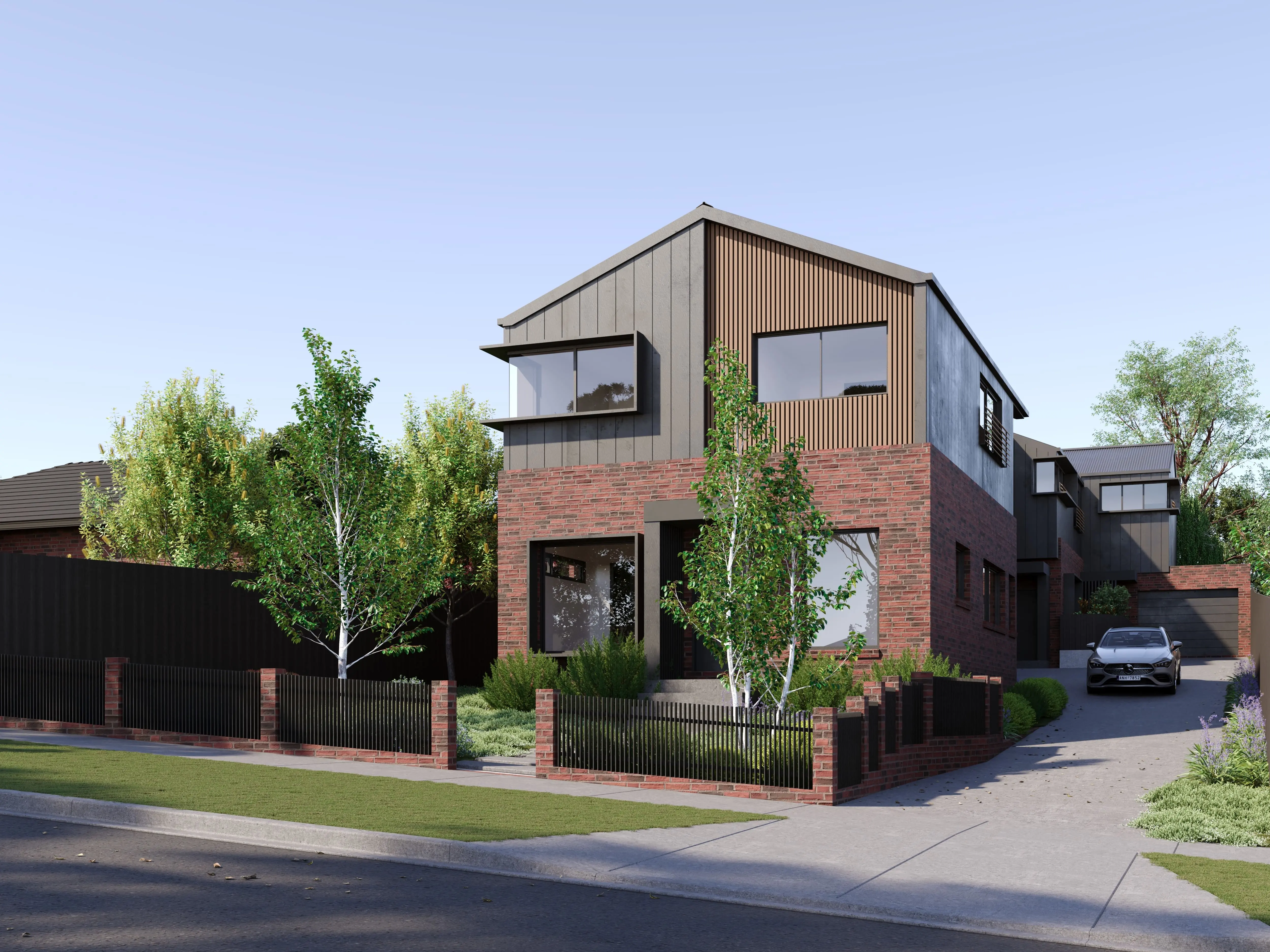 Modern two-story house with red brick base and grey upper level featuring wood accents