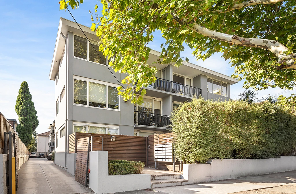 Front exterior view of renovated Windsor apartment with modern finishes and greenery