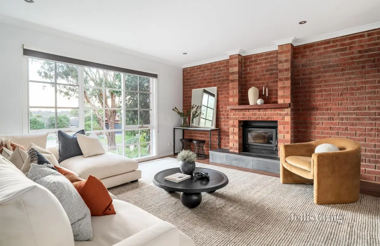 Modern living room with brick fireplace and garden views