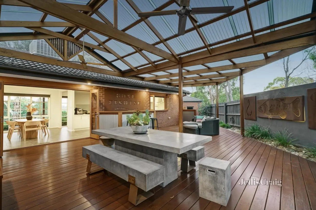 Covered deck with concrete dining set and indoor-outdoor flow